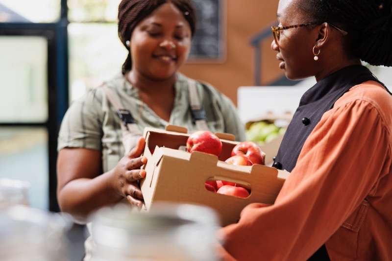 Farmer supplies vendor with organic produce